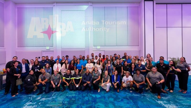 Corporate event group photo for Aruba Tourism Authority, highlighting brand engagement and professional event coverage by Magnetic Media.